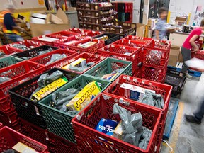 Volunteers at the Calgary Food Bank fill hampers at the warehouse.
