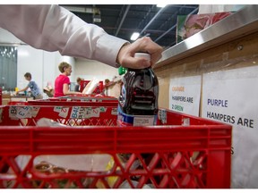 Volunteers at the Calgary Inter-Faith Food bank fill hampers at their warehouse in Calgary.