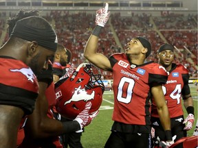 Calgary Stampeders Ciante Evans, right, celebrates his interception on the BC Lions with teammates during CFL action at McMahon Stadium in Calgary, Alta.. on Friday July 29, 2016. Leah Hennel/Postmedia