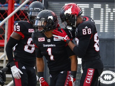 Calgary Stampeders' Lemar Durant, centre, celebrates his touchdown with teammates DaVaris Daniels, left, and Kamar Jorden during first quarter CFL Western Final football action against the B.C. Lions, in Calgary on Sunday, Nov. 20, 2016.