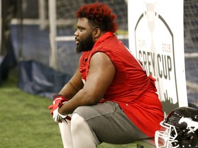 Calgary Stampeders lineman Derek Dennis watches his team practice at Monarch Park dome in preparation for Sundays' Grey Cup game in Toronto, Ont. on Wednesday November 23, 2016. Michael Peake/Toronto Sun/Postmedia Network