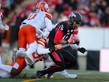Calgary Stampeders Marquay McDaniel is taken down by  BC Lions Solomon Elimimian, middle and Mike Edem during CFL Western Final action at McMahon Stadium in Calgary, Alta.. on Sunday November 20, 2016. Leah hennel/Postmedia