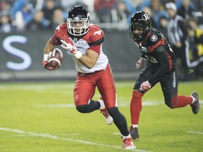 Calgary Stampeders wide receiver Lemar Durant (1) runs in for a touchdown as Ottawa Redblacks defensive back Forrest Hightower (23) defends during third quarter CFL Grey Cup action Sunday, November 27, 2016 in Toronto.