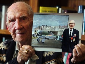 Jack Hilton, who at age 96, is probably the last surviving Canadian Hawker Typhoon pilot from WWII holds a photo of himself and his plane Tuesday September 27, 2016. at his home in Airdrie. He is to be honored this year at the Air Museum Remembrance Day ceremonies.