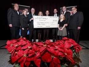 A $100,000 cheque presentation by the Gerry Wood family launches the Salvation Army's Christmas Kettle Campaign during the Hope in the City luncheon at the Hyatt Regency in downtown Calgary, Alta., on Thursday, Nov. 17, 2016. Pictured here are (L-R) Maj. Ron Cartmell, Karen Livick of Salvation Army's Community Services Calgary, Gerry Wood, wife Elaine Wood, keynote speaker Rex Murphy, Salvation Army advisory board member Scott Taylor, Wood children Rory and Megan, and Capt. Mark Stanley. Lyle Aspinall/Postmedia Network