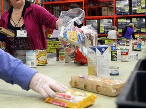 File photo: Volunteers help out the Calgary Food Bank in Calgary on November 17, 2015.