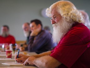 Santa Claus, aka Jeff Badyk, take notes while attending Santa School.