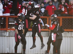 Calgary Stampeders' DaVaris Daniels, centre left, celebrates his touch down with teammates, left to right, Anthony Parker, Rob Cote, and quarterback Bo Levi Mitchell during second quarter CFL Western Final football action against the B.C. Lions in Calgary, Sunday, Nov. 20, 2016.THE CANADIAN PRESS/Todd Korol ORG XMIT: JMC118