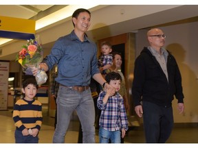Eddie and Rick Jocson are reunited with Reg Reimer and his wife after 39 years (not pictured), at the Calgary International Airport in Calgary on Saturday, Nov. 5, 2016. Reimer, a missionary, aid worker and human rights investigator, rescued them from Laos in 1977, after the boys were separated from their parents, who fled to Regina, Saskatchewan and became refugees. Reimer brought the boys to Saskatchewan on May 9, 1977, but they lost touch until recently.