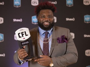Calgary Stampeders offensive lineman Derek Dennis poses backstage after being named Most Outstanding Offensive Lineman at the CFL Awards held in Toronto on Thursday, November 24, 2016.