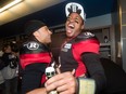 Ottawa Redblacks running back Kienan Lafrance, left, and quarterback Henry Burris celebrate their team's win over the Calgary Stampeders in overtime CFL Grey Cup football action on Sunday, November 27, 2016 in Toronto.