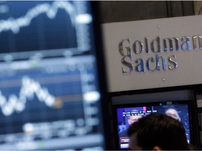 A screen at a trading post on the floor of the New York Stock Exchange is juxtaposed with a booth of Goldman Sachs, which issued a bullish price for oil on Monday.