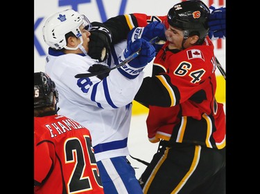 Toronto Maple Leafs Connor Carrick battles against Garnet Hathaway of the Calgary Flames during NHL hockey in Calgary, Alta., on Wednesday, November 30, 2016.