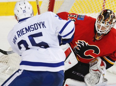 Calgary Flames Chad Johnson makes a save on a shot by James van Riemsdyk of the Toronto Maple Leafs during NHL hockey in Calgary, Alta., on Wednesday, November 30, 2016.