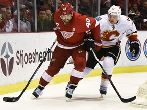 Detroit Red Wings left wing Henrik Zetterberg (40), of Sweden, skates with the puck against Calgary Flames center Matt Stajan (18) during the second period of an NHL hockey game in Detroit, Sunday, Nov. 20, 2016.