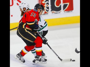 Calgary Flames Johnny Gaudreau collides with Jordie Benn of the Dallas Stars during NHL hockey in Calgary, Alta., on Thursday, November 10, 2016. AL CHAREST/POSTMEDIA
