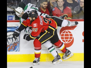 Deryk Engelland of the Calgary Flames hits Antoine Roussel of the Dallas Stars during NHL action in Calgary, Alta., on Thursday, Nov. 10, 2016. Lyle Aspinall/Postmedia Network