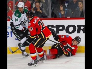 Calgary Flames Johnny Gaudreau hits the ice after colliding with Jamie Benn of the Dallas Stars during NHL hockey in Calgary, Alta., on Thursday, November 10, 2016. AL CHAREST/POSTMEDIA