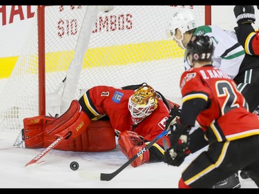 Calgary Flames goalie Brian Elliott stops a puck near Adam Cracknell of the Dallas Stars and Dougie Hamilton of the Calgary Flames during NHL action in Calgary, Alta., on Thursday, Nov. 10, 2016. Lyle Aspinall/Postmedia Network