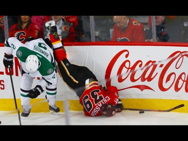 Calgary Flames Alex Chiasson takes a hit from Dan Hamhuis of the Dallas Stars during NHL hockey in Calgary, Alta., on Thursday, November 10, 2016.