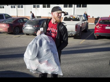 Calgary Stampeders quarterback Bo Levi Mitchell carries a bag of his belongings out of McMahon Stadium in Calgary, Alta., on Tuesday, Nov. 29, 2016. The Stamps were cleaning out their lockers two days after losing the Grey Cup to Ottawa in Toronto. Lyle Aspinall/Postmedia Network