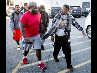 Bakari Grant (R) and  Derek Dennis of the Calgary Stampeders walk with teammates to the team office at McMahon Stadium in Calgary, Alta., on Tuesday, Nov. 29, 2016. The Stamps were cleaning out their lockers two days after losing the Grey Cup to Ottawa in Toronto. Lyle Aspinall/Postmedia Network