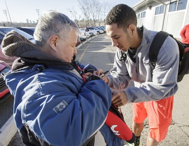 Calgary Stampeders wide receiver Lemar Durant signs an autograph for Kelly Church at McMahon Stadium in Calgary, Alta., on Tuesday, Nov. 29, 2016. The Stamps were cleaning out their lockers two days after losing the Grey Cup to Ottawa in Toronto. Lyle Aspinall/Postmedia Network