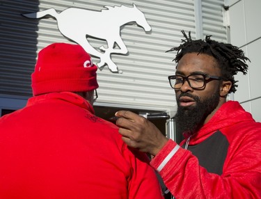 Calgary Stampeders defensive back Josh Bell signs an autograph for Les Wales at McMahon Stadium in Calgary, Alta., on Tuesday, Nov. 29, 2016. The Stamps were cleaning out their lockers two days after losing the Grey Cup to Ottawa in Toronto. Lyle Aspinall/Postmedia Network