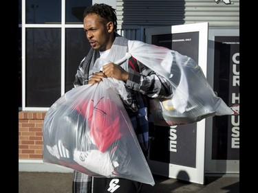Calgary Stampeders wide receiver Bakari Grant carries bags of belongings away from McMahon Stadium in Calgary, Alta., on Tuesday, Nov. 29, 2016. The Stamps were cleaning out their lockers two days after losing the Grey Cup to Ottawa in Toronto. Lyle Aspinall/Postmedia Network
