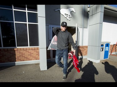 Calgary Stampeders second-string quarterback Andrew Buckley carries belongings out of McMahon Stadium in Calgary, Alta., on Tuesday, Nov. 29, 2016. The Stamps were cleaning out their lockers two days after losing the Grey Cup to Ottawa in Toronto. Lyle Aspinall/Postmedia Network