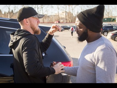 Calgary Stampeders quarterback Bo Levi Mitchell says goodbye to teammate Ja'Gared Davis outside of his car at McMahon Stadium in Calgary, Alta., on Tuesday, Nov. 29, 2016. The Stamps were cleaning out their lockers two days after losing the Grey Cup to Ottawa in Toronto. Lyle Aspinall/Postmedia Network
