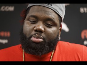 Calgary Stampeders offensive lineman Derek Dennis  speaks with media at McMahon Stadium in Calgary, Alta., on Tuesday, Nov. 29, 2016. The Stamps were cleaning out their lockers two days after losing the Grey Cup to Ottawa in Toronto. Lyle Aspinall/Postmedia Network