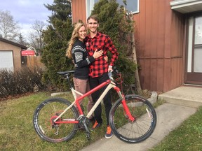 Devin Woodland and his wife with the retrieved bike. (Via Devin Woodland.)