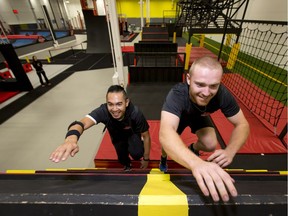 Obstacle coaches Andrew de Jesus (L) and Ben Skuter scramble up an A-frame inside InjaNation Fun and Fitness in Calgary, Alta., on Tuesday, Nov. 15, 2016. Photographed for Herald Weekend Life. Lyle Aspinall/Postmedia Network