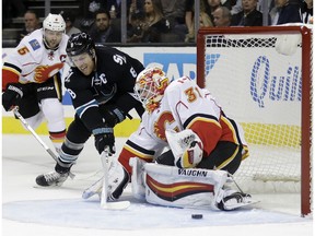 Calgary Flames goalie Chad Johnson (31) stops a shot from San Jose Sharks center Joe Pavelski (8) during the first period of an NHL hockey game Thursday, Nov. 3, 2016, in San Jose, Calif.