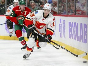 Calgary Flames left wing Johnny Gaudreau (13) controls the puck as he is pursued by Minnesota Wild defenseman Ryan Suter (20) during the second period. Gaudreau had the only goal of the night as Calgary won 1-0.