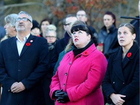 Jose Rodriguez, editor of the Calgary Herald and Calgary Sun, left, journalist Gwendolyn Richards and Calgary Herald reporter Colette Derworiz attend the Sunrise Ceremony at the Field of Crosses in honour of journalist Michelle Lang in Calgary Thursday November 3, 2016