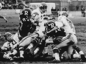 FILE - Ottawa Rough Riders quarterback Russ Jackson (12) scores in the third quarter of the 1968 Grey Cup in Toronto.