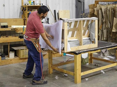 Applying outside padding on a love seat.