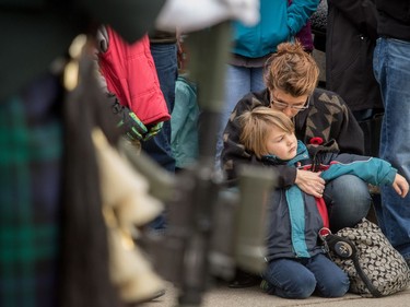 Marnie Perrault and son Wyatt relax during the ceremony at the cenotaph at Central Memorial Park for Remembrance Day ceremonies in Calgary, Ab., on Friday November 11, 2016.