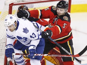 Toronto Maple Leafs' Nazem Kadri, left is pushed away from the Calgary net by Calgary Flames' Mark Giordano during second period NHL action in Calgary, Alta., Tuesday Feb. 9, 2016.
