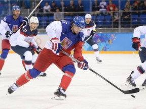 Czech Republic's Michael Frolik (C) handles the puck  during the Men's Ice Hockey Quarterfinals match between the USA and the Czech Republic at the Shayba Arena during the Sochi Winter Olympics on February 19, 2014.