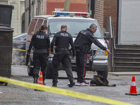 A jacket and other debris lay on the ground as police investigate a shooting in the alley behind The Palomino on Centre St. SW in Calgary, on March 21, 2015.