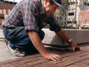Gioachino De Marchi   laying personalized bricks at Olympic Plaza. June 20, 1987. At the time, the worker jokingly told the photographer his name was Pietro Bordin, who was a close colleague.