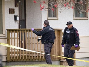 Police at the scene of a homicide in the 2400 Block of 47 St. SE in Calgary on Friday.