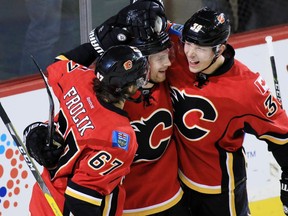 The Calgary Flames' Matt Stajan, centre, celebrates scoring with Michael Frolik, left and Alex Chiasson in the first period of NHL action at the Scotiabank Saddledome in Calgary on Wednesday November 30, 2016.  GAVIN YOUNG/POSTMEDIA