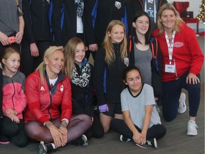 Olympic gold medalist Hayley Wickenheiser, right, and bobsled gold medalist Kaillie Humphries, second from left, pose with young women at her annual Canadian Tire Wickenheiser Female World Hockey Festival opening day Friday November 18, 2016 at Winsport. They had just gone through a workout session with Humphries.