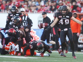 Calgary Stampeders Alex Singleton celebrates after a stopping Jeremiah Johnson of the BC Lions during 2016 CFL's West Division Final in Calgary, Alta., on Sunday, November 20, 2016. AL CHAREST/POSTMEDIA