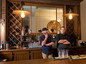 The Plowshare Artisan Diner's David Carruthers, left and Michael Scarcelli stand by the bar which includes reclaimed wood and metal from the Grain Exchange Building where the restaurant is located in downtown Calgary.