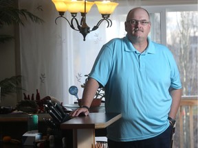 Philip Howard stands in the kitchen of his Strathmore home. He was laid off a year ago from his job as a piping designer in the oil and gas industry.